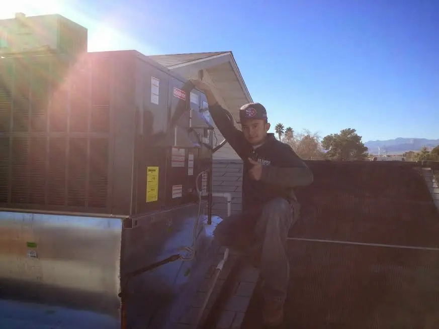 HVAC technician performing Boiler Repair on a rooftop unit in Blacklick Estates
